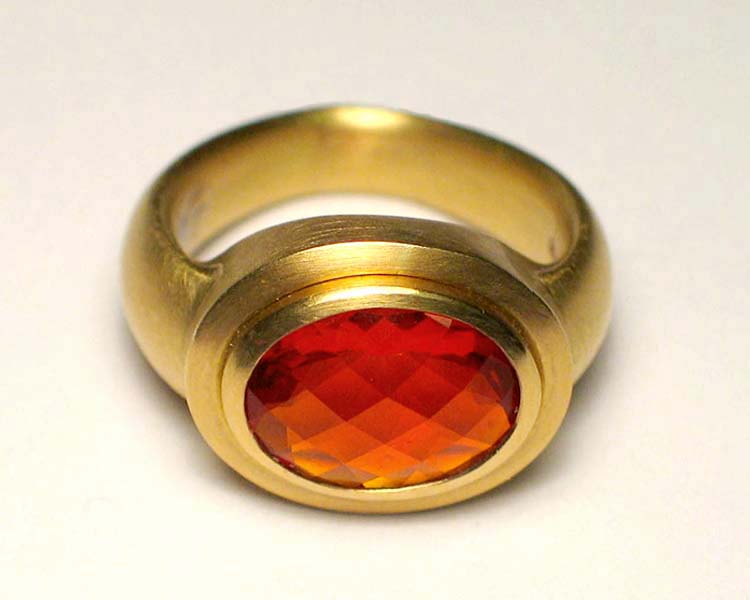 Oval Checkerboard Cut Fire Opal in 18K Yellow Gold Ring Setting with Step Bezel and pointed Bottom Tip.