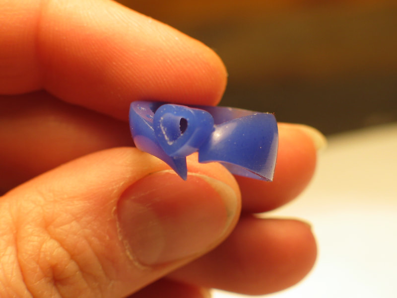 Artisan hand carving in wax of a heart diamond engagement ring.