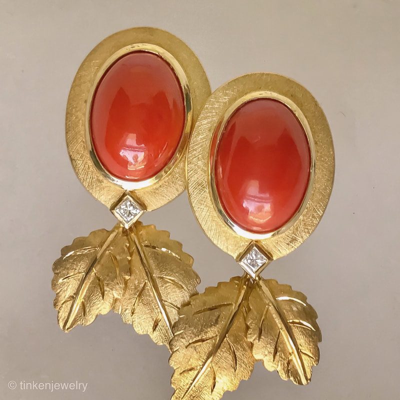 Oval Coral and Square Diamond 18K Yellow Gold Earrings with Leaf Design Elements hanging from the bottom.